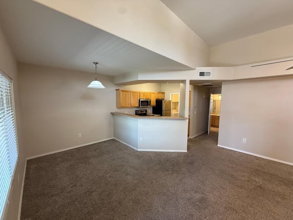 Open great room with soaring ceilings, neutral d cor, and direct connection to the kitchen. This versatile living space offers comfort, natural light, and excellent entertaining potential.
