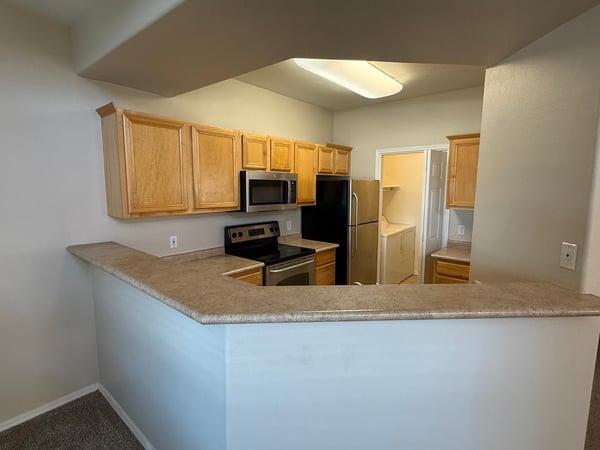 Open kitchen featuring a spacious breakfast bar, abundant cabinetry, and convenient access to the living area. Perfect for hosting guests or enjoying casual meals at home.