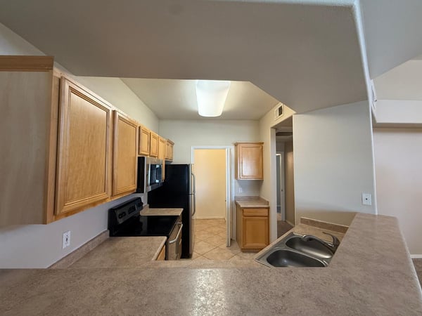 Well-designed kitchen with extensive storage, ample preparation space, and a practical layout. Easy access to the laundry room enhances everyday convenience.