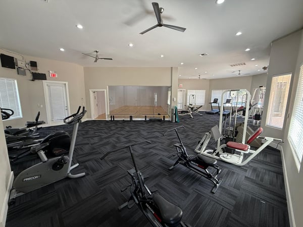 Large community gym featuring cardio equipment, exercise bikes, weight stations, and spacious workout zones. This Phoenix community offers convenient access to fitness amenities that support healthy living.