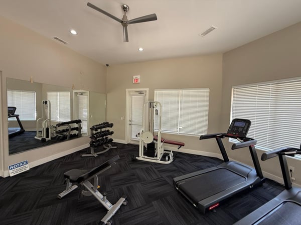 Well-maintained fitness center featuring cardio machines, weight equipment, and spacious exercise areas. Residents enjoy access to resort-style amenities within this desirable Phoenix community.