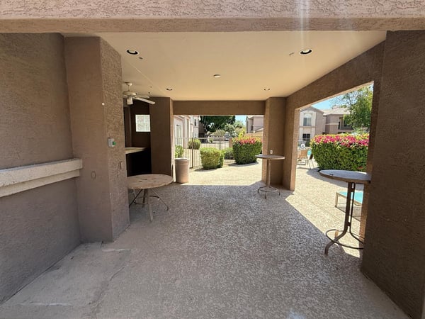 Covered outdoor gathering space near the community pool, offering comfortable seating and a shaded retreat for socializing. This desirable Phoenix community amenity enhances the overall lifestyle experience.