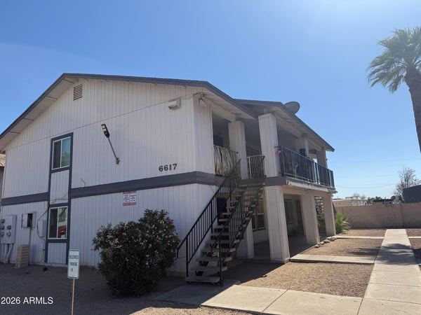 Inviting exterior perspective showcasing the property's well-kept grounds, designated parking, and mature landscaping. Residents enjoy a convenient Glendale location near dining, retail, and recreational opportunities.