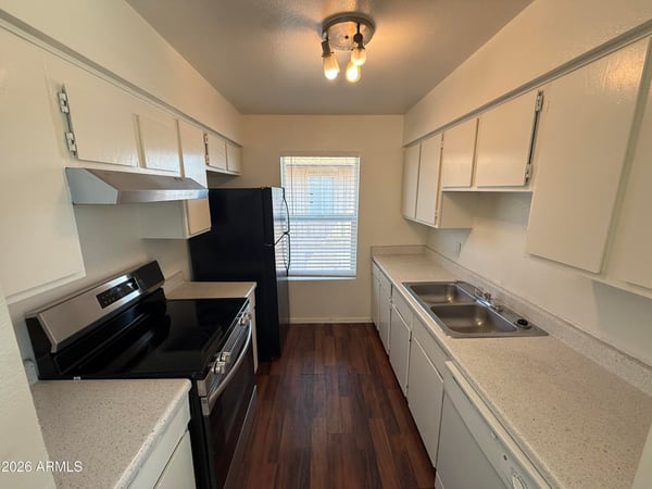 Functional galley-style kitchen featuring extensive cabinetry, generous counter space, and modern appliances. Designed for convenience, this space supports both everyday cooking and efficient organization.