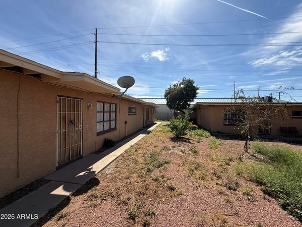 Attractive courtyard environment with desert landscaping, mature trees, and convenient pathways connecting residences. This low-maintenance outdoor setting enhances the appeal of comfortable Phoenix living.