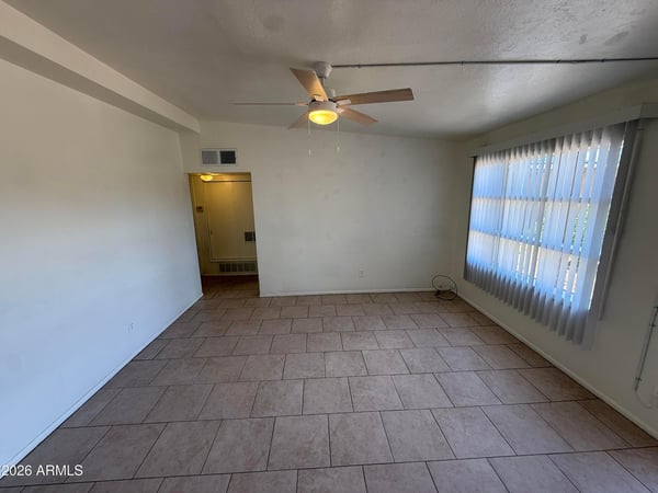 Bright interior living space enhanced by large windows, natural light, and neutral d cor. The open floor plan creates a welcoming atmosphere while maintaining practical functionality.