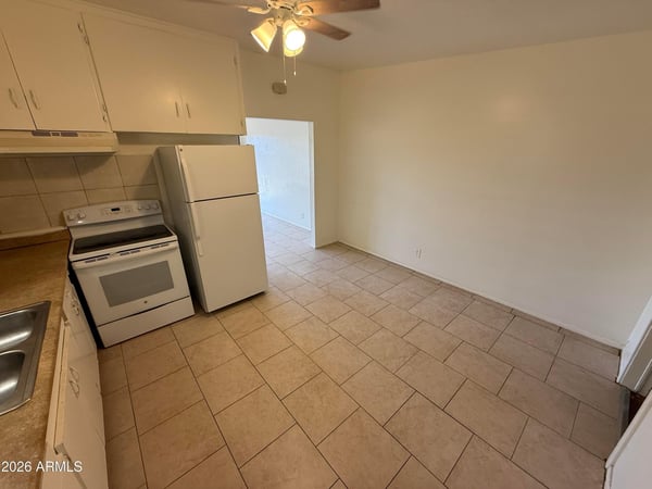 Spacious eat-in kitchen with room for casual dining, abundant cabinet storage, and durable tile flooring. The efficient design maximizes both workspace and comfort while supporting everyday convenience.