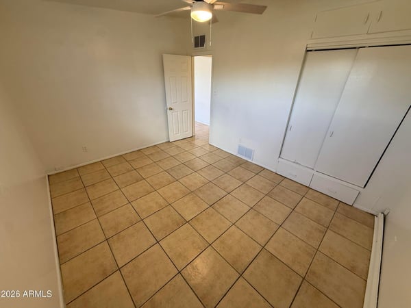 Comfortable bedroom offering built-in closet storage, ceiling fan, and easy-care tile flooring. The generous dimensions provide flexibility for larger furniture and personalized d cor.