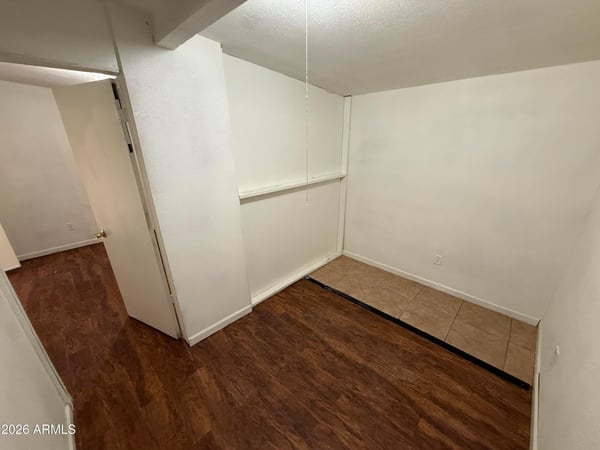 Flexible interior space with attractive wood-look flooring and neutral finishes. Ideal for a home office, study space, craft room, or additional living area to fit a variety of lifestyle needs.
