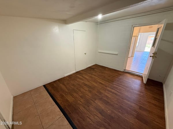 Expansive bonus room with easy access to the home's main living areas and a versatile layout. The wood-look flooring and neutral palette create a comfortable setting for work, hobbies, or relaxation.