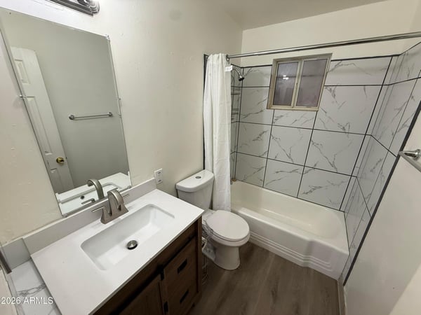 Beautifully updated bathroom showcasing a contemporary vanity, modern faucet, designer tile shower surround, and clean finishes. The stylish upgrades create a fresh and inviting space for daily routines.