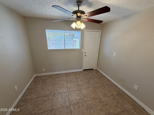 Multi-use room with tile flooring and direct access to adjoining living areas. Perfect for remote work, studying, creative projects, or additional living space tailored to your needs.