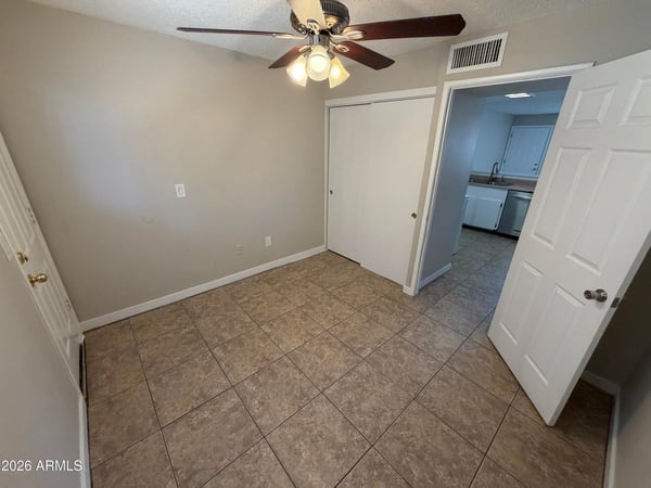 Private flex room featuring a ceiling fan, tile flooring, and natural light. A versatile area that can function as a home office, study room, workout area, or guest space.
