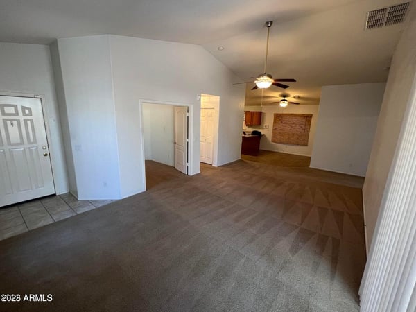 Open-concept great room featuring soaring ceilings and easy access to adjacent living spaces. The flowing floor plan creates a welcoming atmosphere perfect for modern living and entertaining.