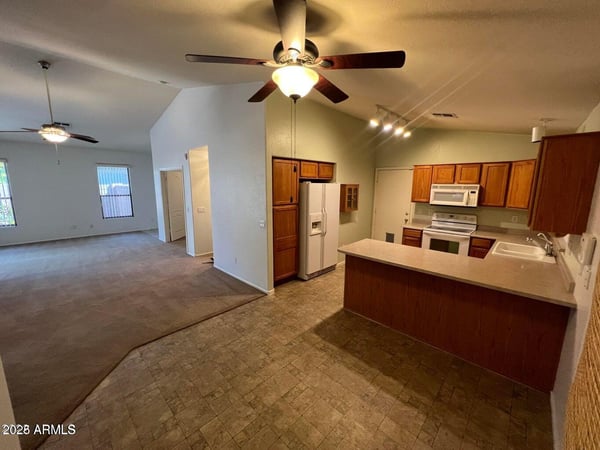 Kitchen overlooks the main living area, creating a connected and spacious feel throughout the home. Ample storage and counter space support both daily routines and entertaining needs.