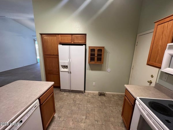 Well-appointed kitchen offering extensive cabinetry, pantry storage, generous counter space, and included appliances. Designed for convenience, this space supports both meal preparation and everyday living.