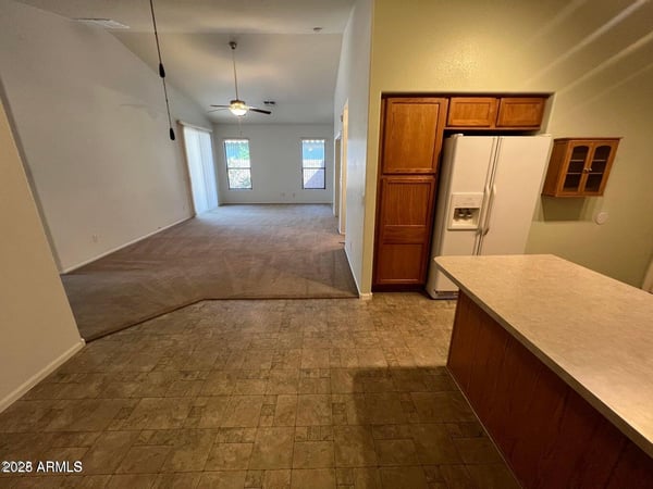 Open kitchen overlooking the spacious living area, creating excellent flow throughout the home. The functional layout encourages gathering, entertaining, and comfortable day-to-day living.