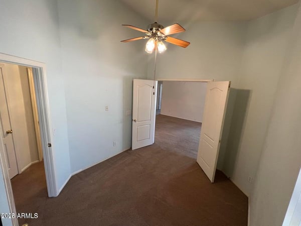 Spacious bonus room featuring high ceilings and flexible use potential. Perfect for remote work, guests, a fitness area, or additional living space tailored to your needs.