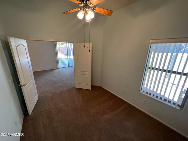 Light-filled den with a functional layout and neutral finishes, offering endless possibilities for work, study, entertainment, or guest accommodations within this thoughtfully designed home.
