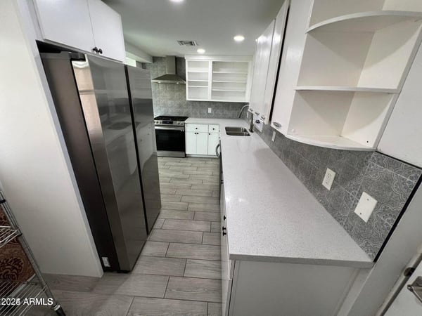 Offering generous cabinetry, stainless steel appliances, quartz countertops, and stylish finishes, this remodeled kitchen delivers the storage and workspace today's buyers are seeking.