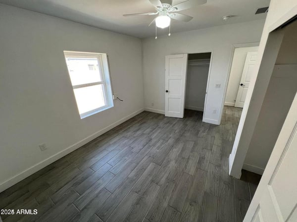 Designed for comfort and functionality, this bedroom showcases modern flooring, clean finishes, ample natural light, and convenient closet access. The flexible space easily adapts to a variety of living needs while complementing the home's updated interior.