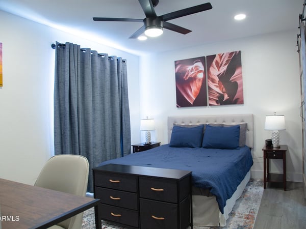 This spacious bedroom provides a comfortable setting with modern updates, neutral finishes, and room for a home office or additional furnishings. A perfect retreat after enjoying everything Tempe has to offer.