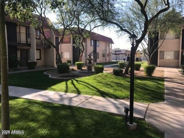 Manicured lawns, mature landscaping, and inviting gathering spaces create a welcoming community environment. Residents enjoy a blend of greenery and outdoor relaxation areas.