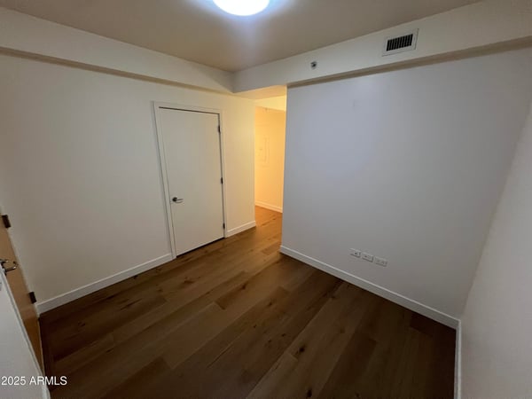 Multi-purpose room featuring wood flooring and a versatile layout ideal for remote work, hobbies, fitness equipment, or additional living space. Designed to adapt to changing lifestyle needs.