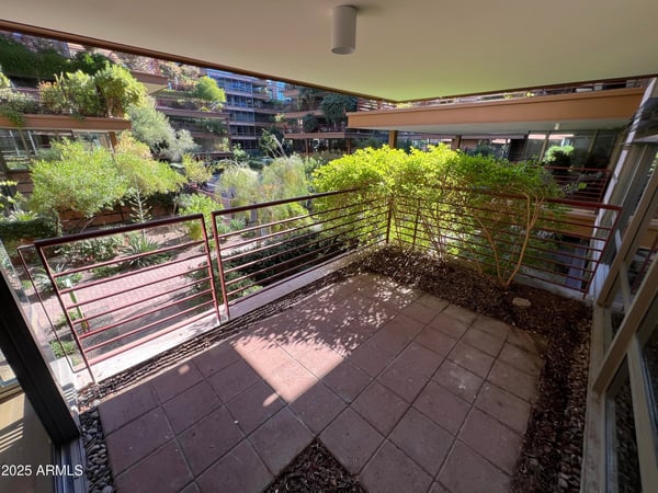 Private patio overlooking beautifully maintained grounds and garden pathways. This peaceful outdoor setting enhances the home's resort-style appeal and indoor-outdoor living experience.