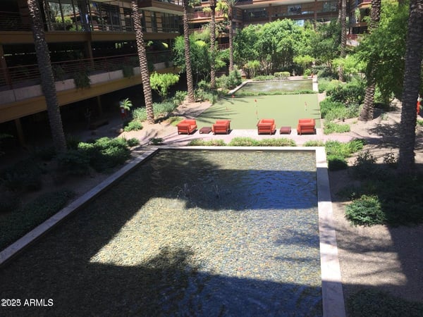 Stunning overhead view featuring the community fountain, putting green, outdoor seating areas, and professionally maintained landscaping. These impressive amenities create an inviting environment that enhances the Scottsdale lifestyle experience.