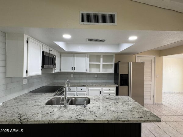 Beautifully updated kitchen with granite counters, recessed lighting, and seamless access to the main living area. Perfect for hosting family and friends.