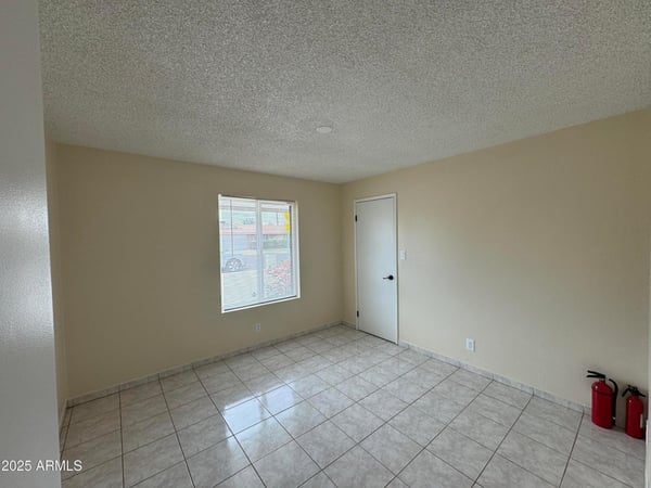 Bright bedroom featuring a modern ceiling fan, neutral color palette, and easy-care tile flooring. The flexible floor plan accommodates a variety of lifestyle needs.