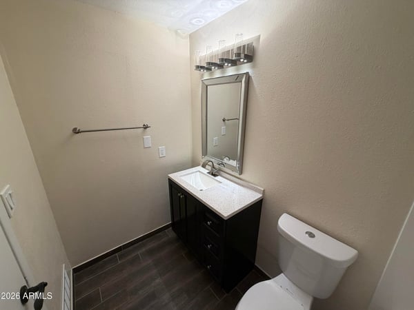 Well-maintained guest bathroom featuring a refreshed vanity, upgraded lighting, stylish mirror, and modern finishes. Thoughtful updates create a welcoming space that blends style and practicality.
