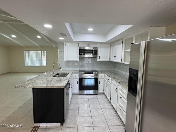 Bright kitchen offering extensive counter space, stainless appliances, and ample cabinet storage. The open layout makes meal preparation and entertaining easy.