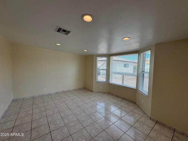 Charming flex room enhanced by attractive bay windows that create a bright and welcoming atmosphere. Perfect for a home office, sitting room, hobby space, or additional bedroom, this versatile area offers endless possibilities.