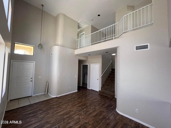 Experience a spacious interior highlighted by vaulted ceilings, architectural details, and a loft overlook. Natural light enhances the home's airy feel while providing a warm and welcoming atmosphere.