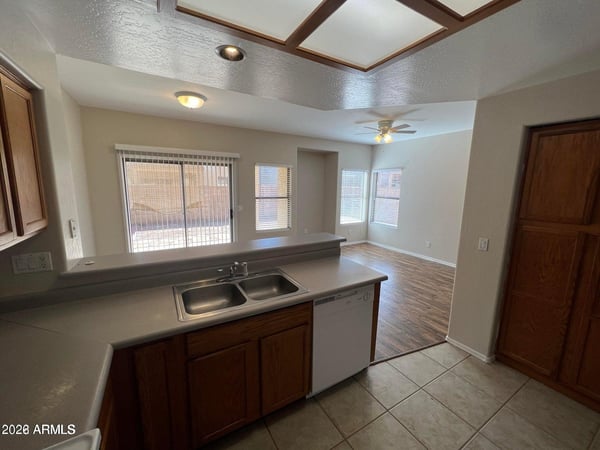 This thoughtfully designed kitchen features extensive cabinetry, ample prep space, and a breakfast bar that overlooks the living area. Its functional layout supports both everyday cooking and entertaining.