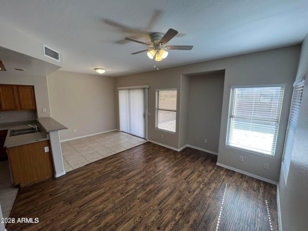 Enjoy casual dining with views of the backyard and convenient access through the sliding glass door. Large windows bring in natural light, creating a cheerful space for meals and gatherings.