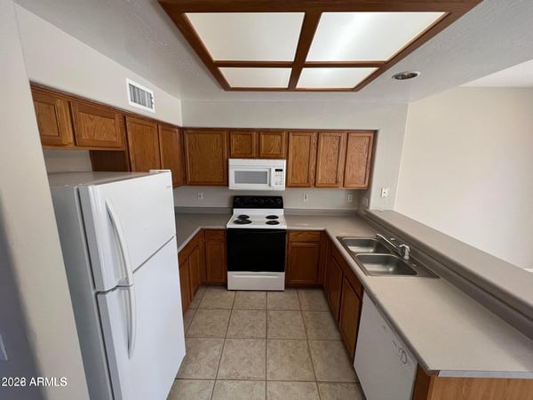 Featuring generous cabinetry, included appliances, and practical workspace, this kitchen is designed to keep everything within easy reach. Its central location makes it a natural hub for daily life and entertaining.