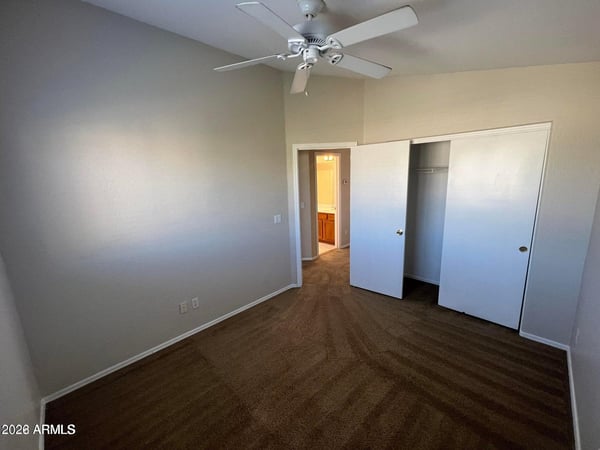 A bright and functional bedroom offering closet storage, neutral finishes, and a ceiling fan. This versatile space can easily serve as a guest room, office, hobby room, or bedroom.