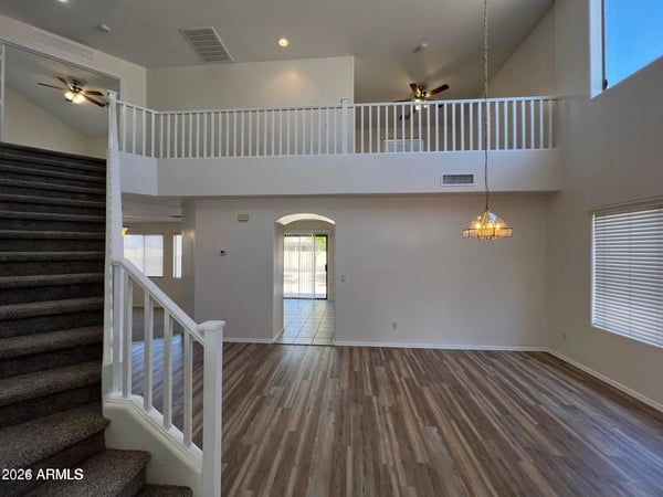 The open design features loft-style architecture, soaring ceilings, and abundant natural light. This impressive gathering space creates a sense of openness throughout the home.