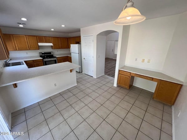 This well-designed kitchen includes extensive storage, abundant counter space, and a built-in workstation. The efficient layout supports cooking, organization, and multitasking with ease.