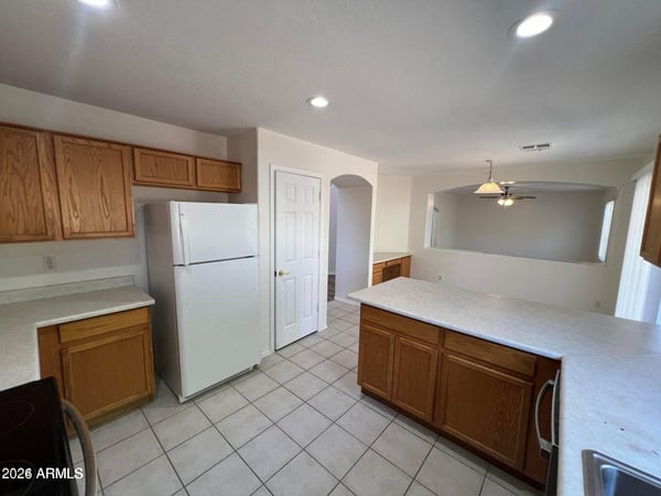 This well-designed kitchen features tile flooring, ample storage, and an open connection to the dining area. The spacious layout is ideal for entertaining and everyday family living.
