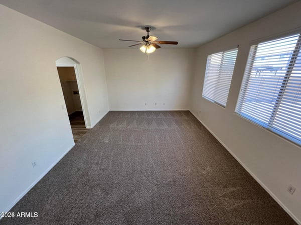 Multiple windows and generous dimensions make this primary suite feel bright and inviting. The large floor plan offers flexibility for a sitting area, workspace, or reading nook.