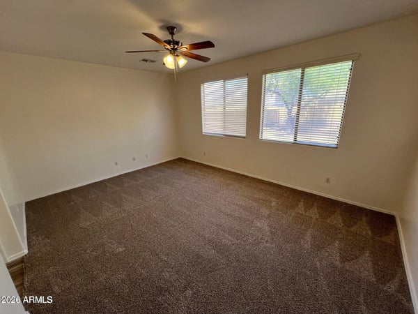 Enjoy the comfort of this spacious primary suite featuring plush carpeting, abundant natural light, and plenty of room for oversized furnishings. The inviting layout creates a peaceful retreat at the end of the day.