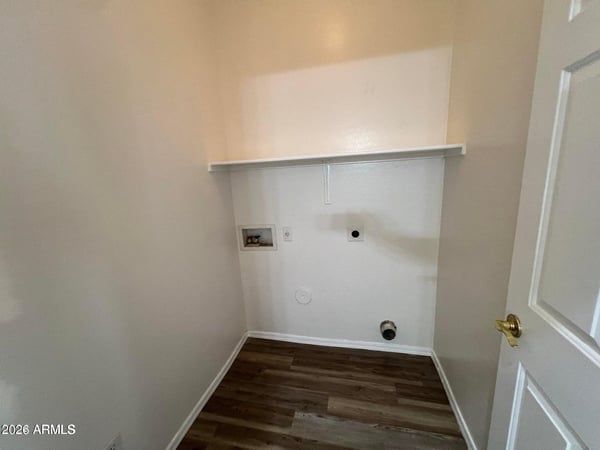 Functional laundry room with utility connections, storage shelf, and easy-care flooring. Designed for convenience, this space helps simplify everyday household routines.
