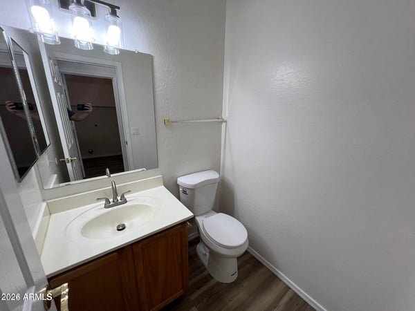 Well-appointed powder room featuring updated fixtures, modern vanity lighting, and durable flooring. A practical and attractive space for guests and daily use.