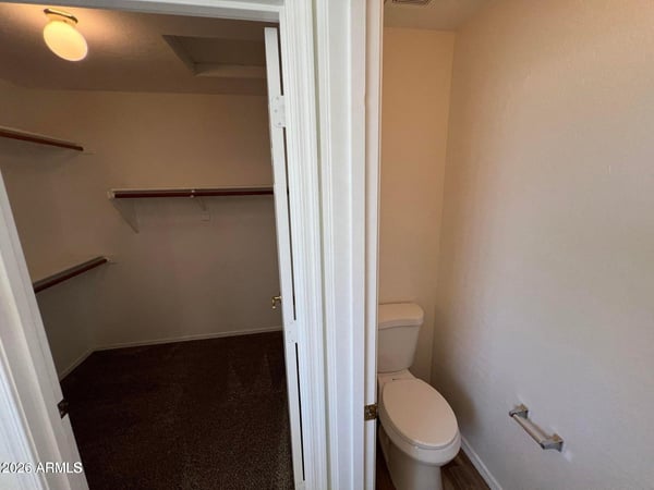 Dedicated water closet and direct access to the walk-in closet enhance the functionality of the primary suite. The efficient design creates a comfortable and private owner s retreat.