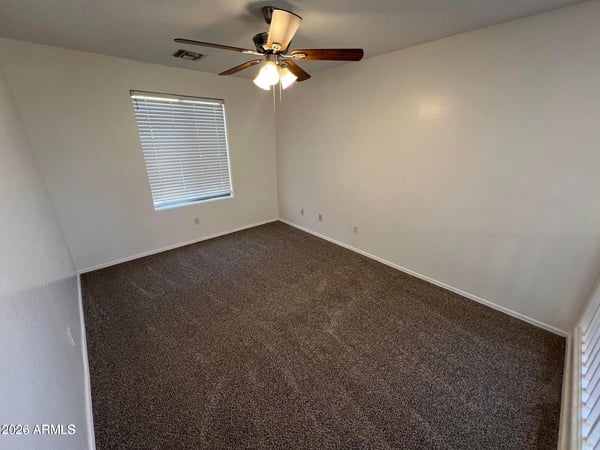 Comfortable upstairs bedroom with fresh carpeting, ceiling fan, neutral d cor, and abundant natural light. A flexible space suited for a variety of living needs.