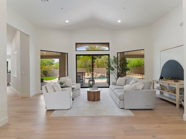 Beautiful great room overlooking the backyard through oversized windows and sliding glass doors. The seamless connection between indoor and outdoor living enhances the home's luxurious Scottsdale lifestyle.
